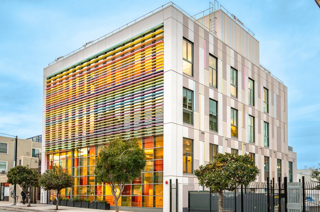 The Mission campus on its street corner, the facade striped with bands of colored glass